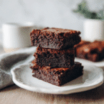 Stack of no-fail gluten-free brownies in bright natural light