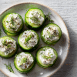 Cucumber Cups with Herbed Cream Cheese served on white plate