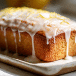 Gluten-Free Lemon Loaf Cake with glaze on platter