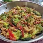 A colorful ground turkey stir fry with vegetables in a skillet