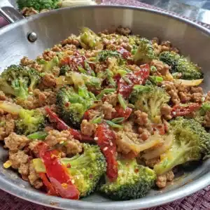 A colorful ground turkey stir fry with vegetables in a skillet