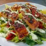 Blackened Salmon Caesar Salad served with creamy tahini dressing