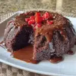 Gluten-free chocolate cake sliced and garnished with chocolate shavings