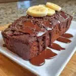 Healthy chocolate banana bread sliced on a wooden table