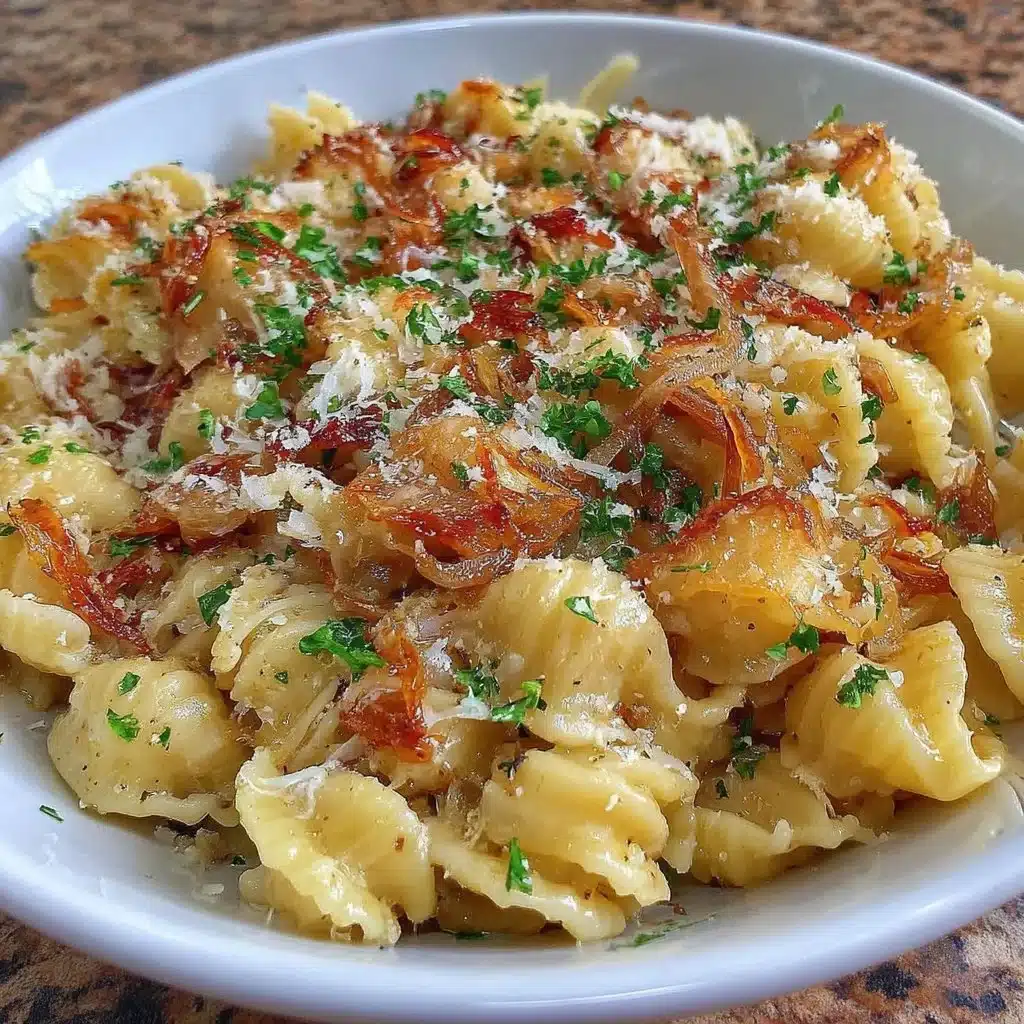 Creamy caramelized onion pasta garnished with herbs and cheese
