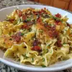 A bowl of gluten-free egg noodles served with fresh vegetables and sauce.