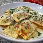 Delicious gluten free ravioli served with fresh herbs and sauce