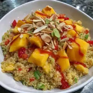 Vibrant Mango Quinoa Salad served at a party with colorful ingredients