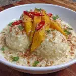 Delicious mango sticky rice dessert with ripe mango and coconut sauce.