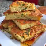 Gluten-free focaccia bread fresh out of the oven with herbs and olive oil.