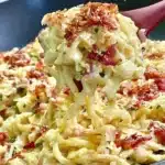 Delicious creamy cabbage carbonara served in a bowl with herbs and parmesan
