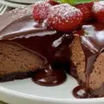 Gluten free chocolate cheesecake served on a plate with chocolate drizzle