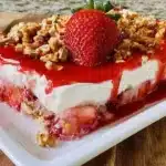 Strawberry Pretzel Salad featuring layers of strawberries, cream, and a pretzel crust