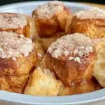 A delicious gluten free monkey bread served on a plate, topped with caramel.