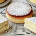 Gluten Free Vanilla Cake topped with fresh berries and cream