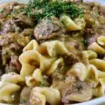 Delicious gluten-free beef stroganoff served on a plate with garnishes