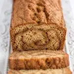 Sliced Cinnamon Swirl Zucchini Bread on a wooden board, gluten-free and dairy-free