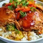 Crockpot Teriyaki Chicken served in a bowl with steamed rice and vegetables.