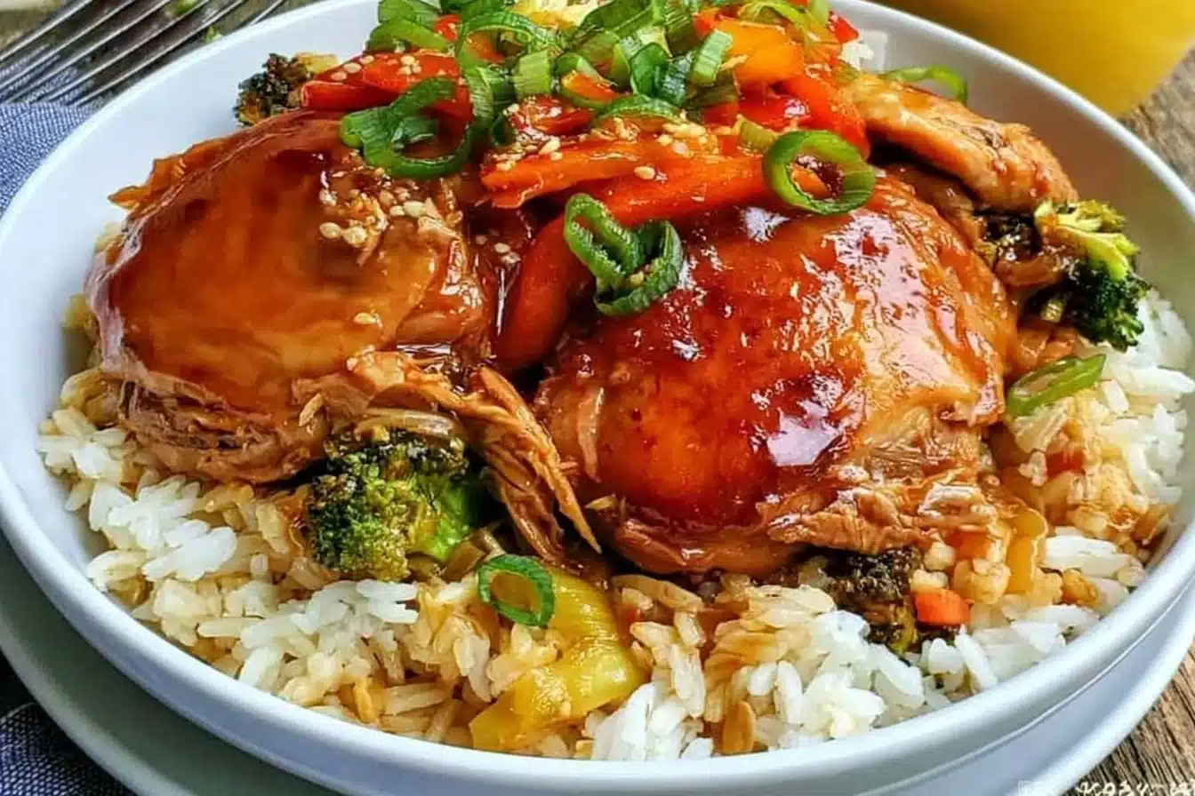 Crockpot Teriyaki Chicken served in a bowl with steamed rice and vegetables.