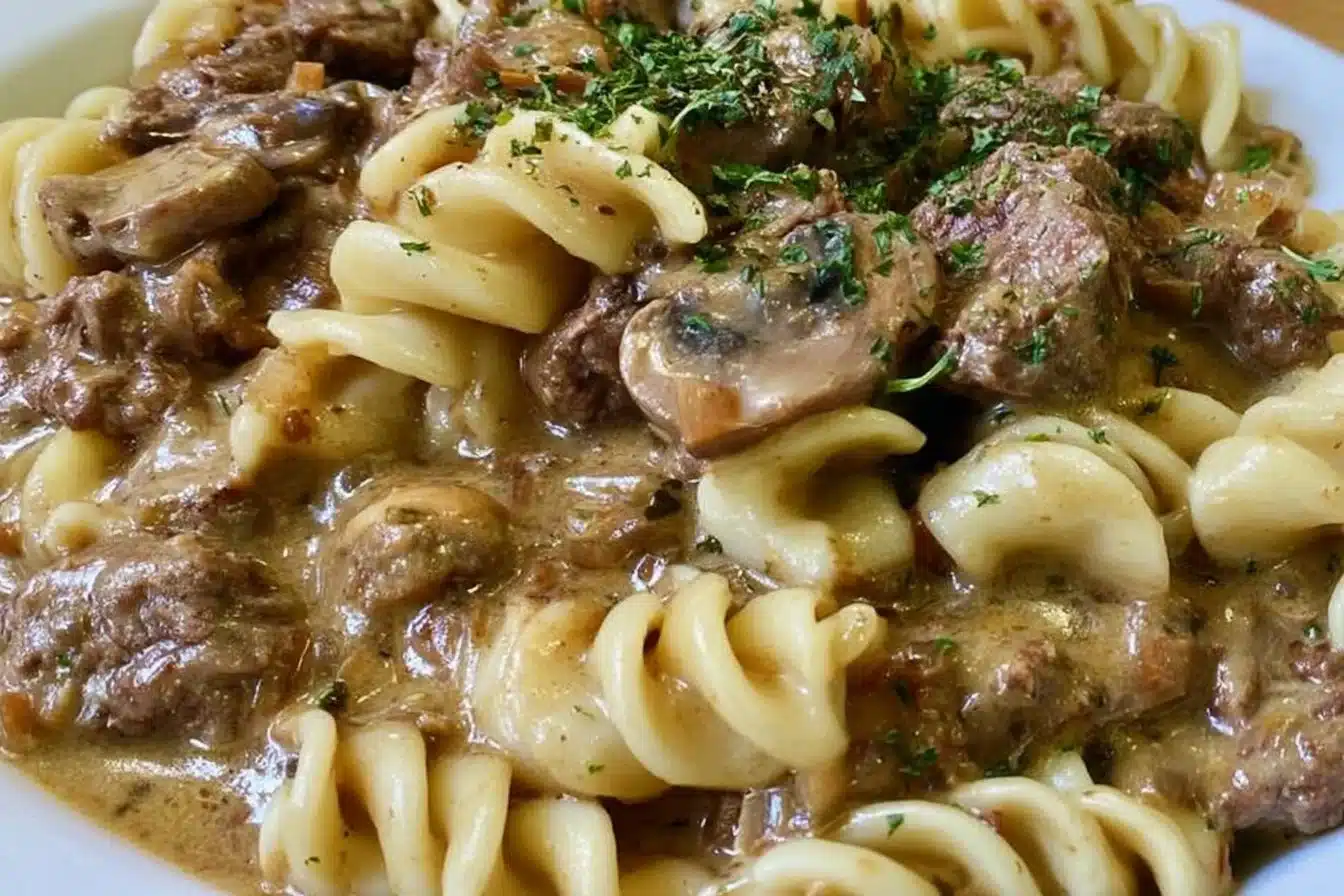 Bowl of gluten-free, dairy-free beef stroganoff topped with fresh parsley