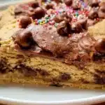 Delicious gluten free cookie cake decorated with chocolate chips and frosting.
