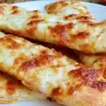 Gluten-free garlic pizza breadsticks served with marinara sauce.