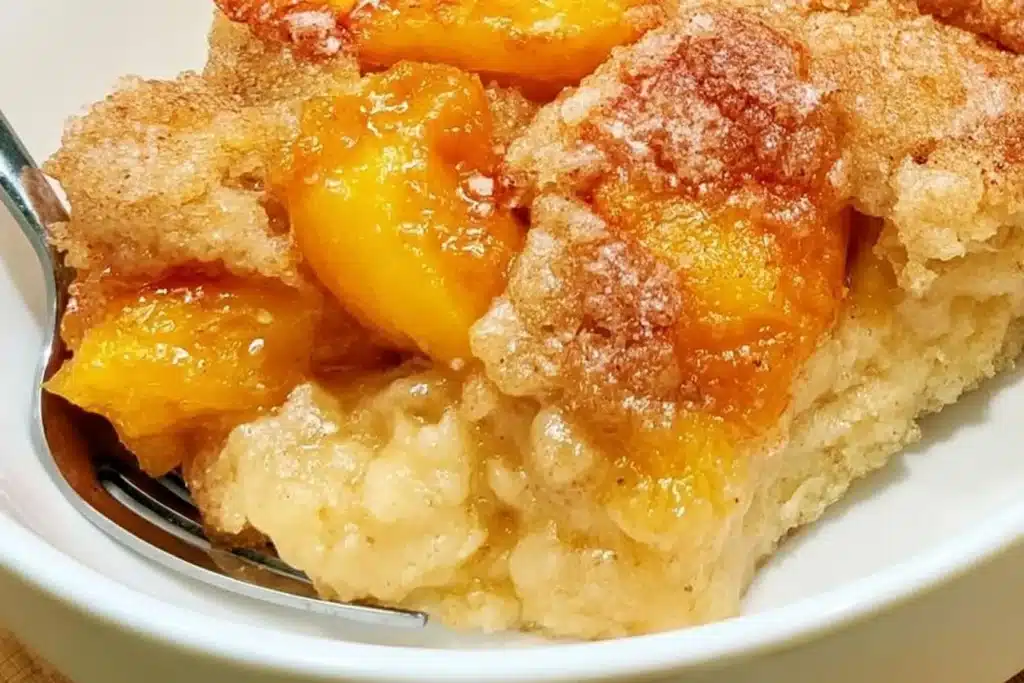 Gluten-free peach cobbler served in a dish with fresh peaches and crust