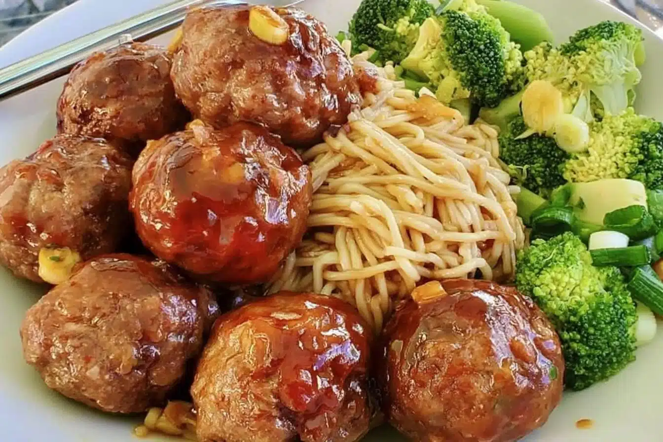 Honey ginger meatballs served on a plate with a side of vegetables