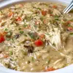 Bowl of Slow Cooker Chicken Wild Rice Soup with vegetables and herbs