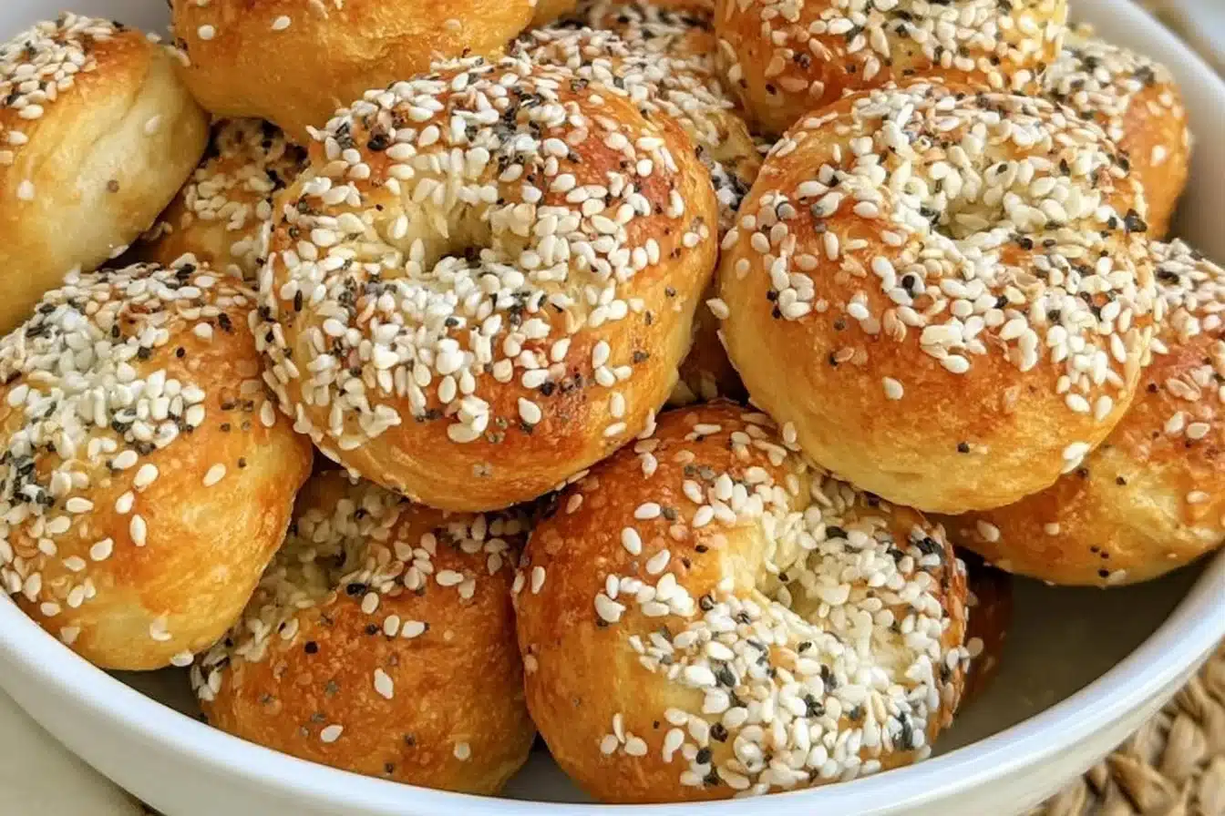 Homemade mini bagels fresh out of the oven with a golden brown crust.