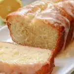 Gluten-free lemon loaf with glaze on a rustic wooden table