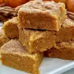 Delicious vegan pumpkin bars topped with a sugar cookie layer, perfect for fall desserts.