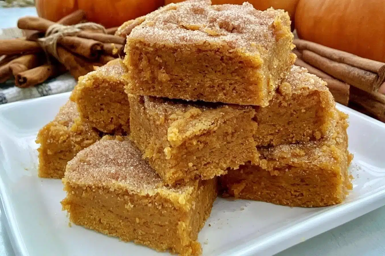 Delicious vegan pumpkin bars topped with a sugar cookie layer, perfect for fall desserts.