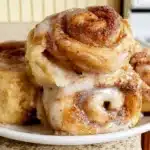 Freshly baked gluten free cinnamon rolls on a wooden table