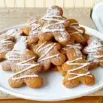 Plate of easy gluten free gingerbread cookies decorated with icing.