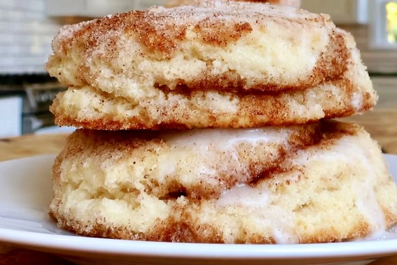 Gluten-free cinnamon biscuits served on a plate with warm cinnamon drizzle
