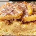 Gluten-free cinnamon sugar apple cake on a plate garnished with cinnamon